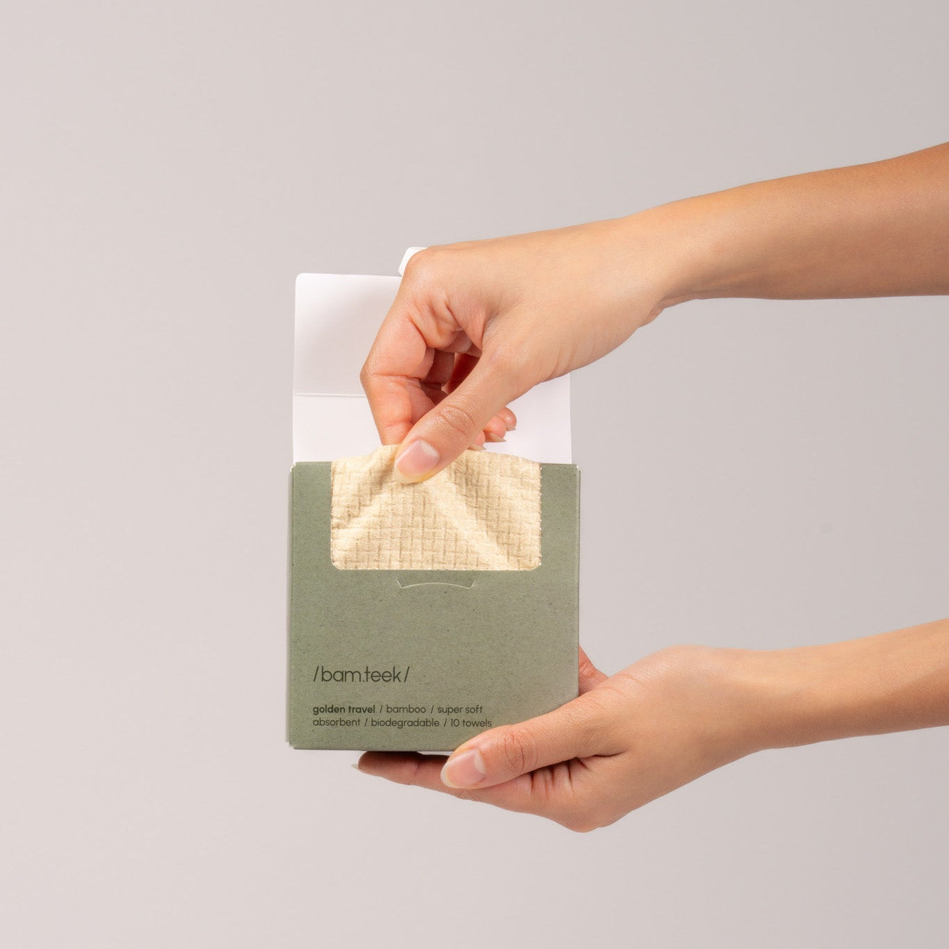 Golden Travel Bundle showing a person holding a soft bamboo towel designed for sensitive skincare. Golden Travel Bundle showing a person holding a soft bamboo towel designed for sensitive skincare.