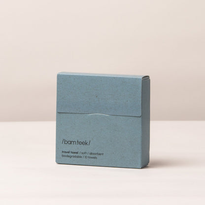 Travel Bundle featuring a hand pulling a single-use travel towel from its packaging.